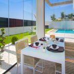 Terraza con cerramiento acristalado y comedor exterior – fotografía inmobiliaria